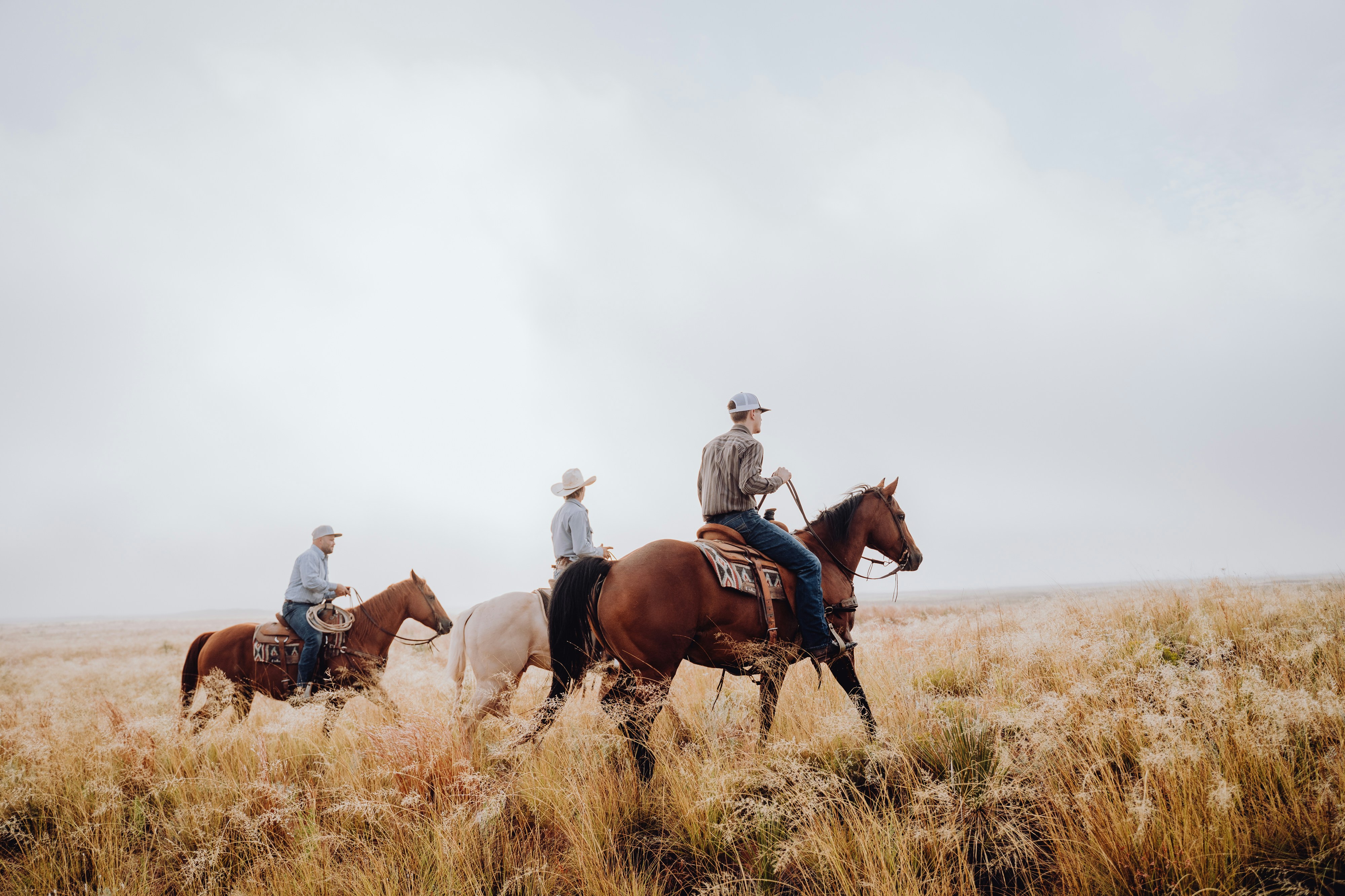 Family riding horses on Texas land